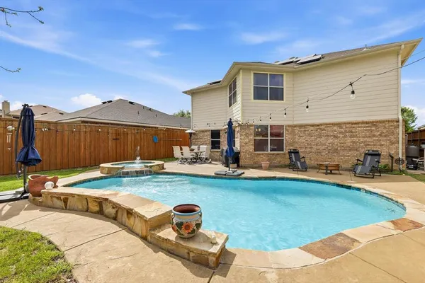 a view of a house with swimming pool and sitting area