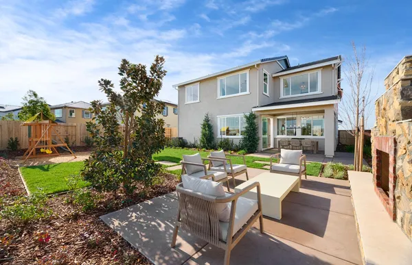a view of a patio with couches table and chairs potted plants and palm trees