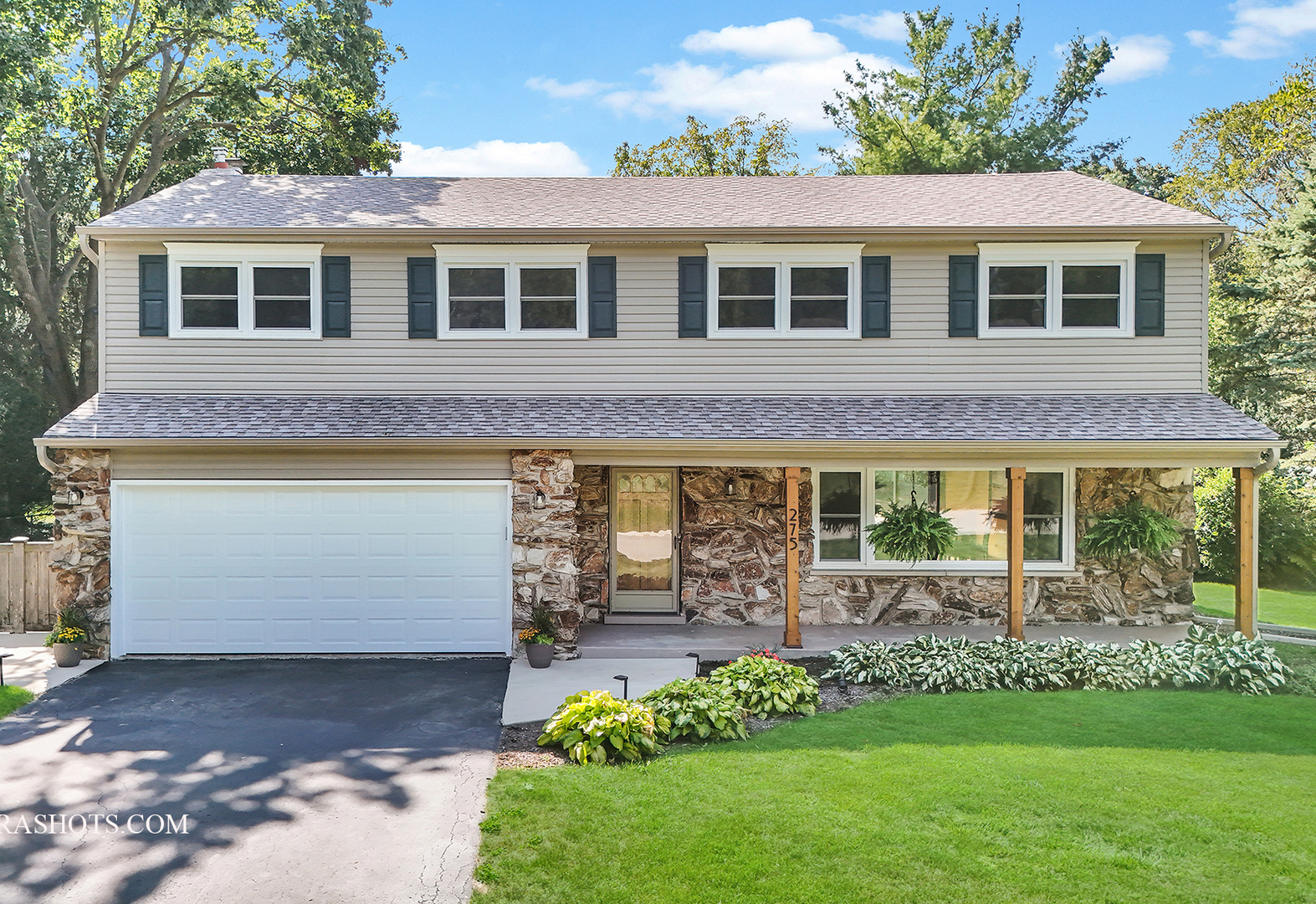 a front view of a house with garden