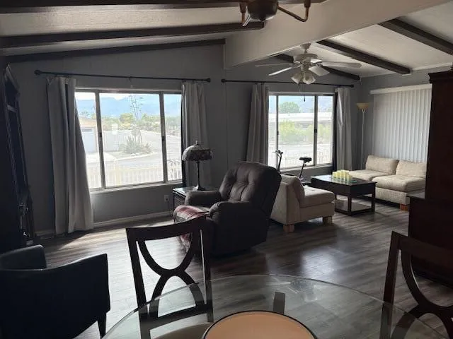 a living room with furniture and a floor to ceiling window