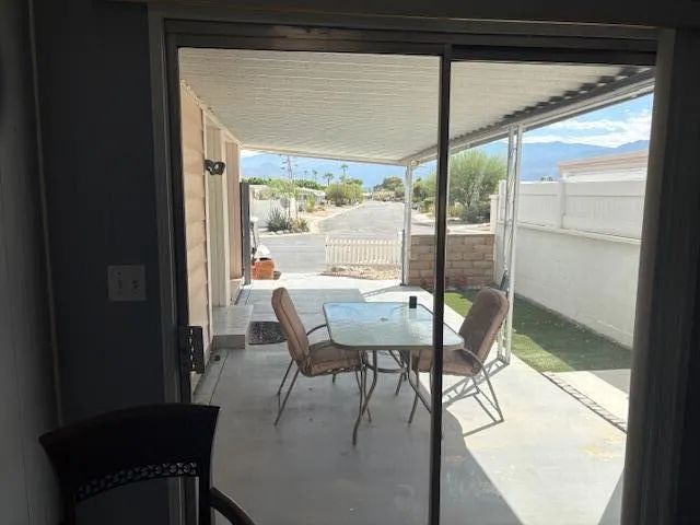 a view of a dining room with furniture and a window