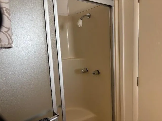 a bathroom with a glass shower door