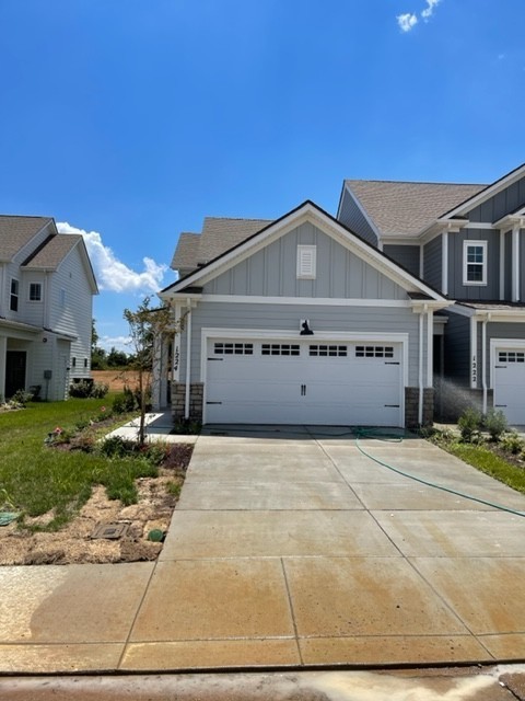 1224 June Wilde Ridge Spring Hill, TN 37174 - Photo 1 of 17 a front view of a house with a yard and garage