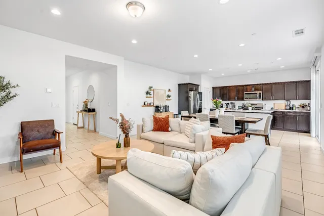 a living room with furniture and kitchen view