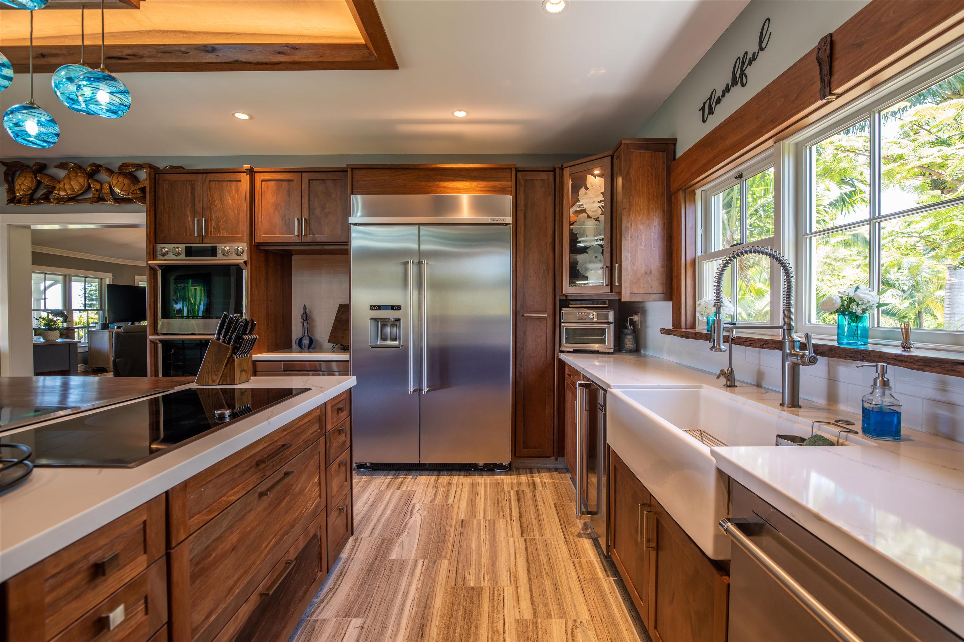 65 North Holokai Road Haiku, HI 96708 - Photo 12 of 50 a kitchen with stainless steel appliances granite countertop a sink and a refrigerator