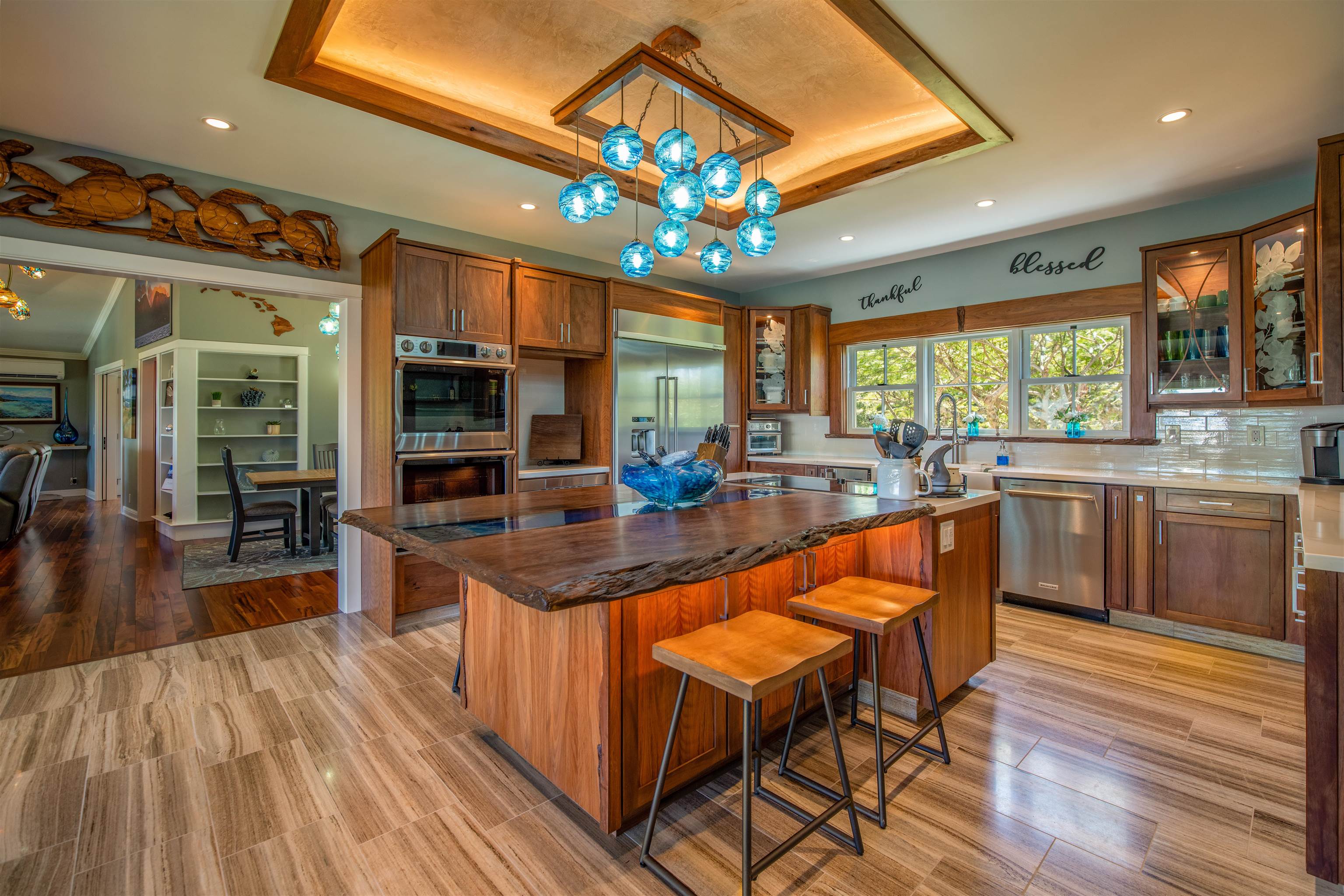 65 North Holokai Road Haiku, HI 96708 - Photo 14 of 50 a kitchen with stainless steel appliances granite countertop counter space a dining table and chairs