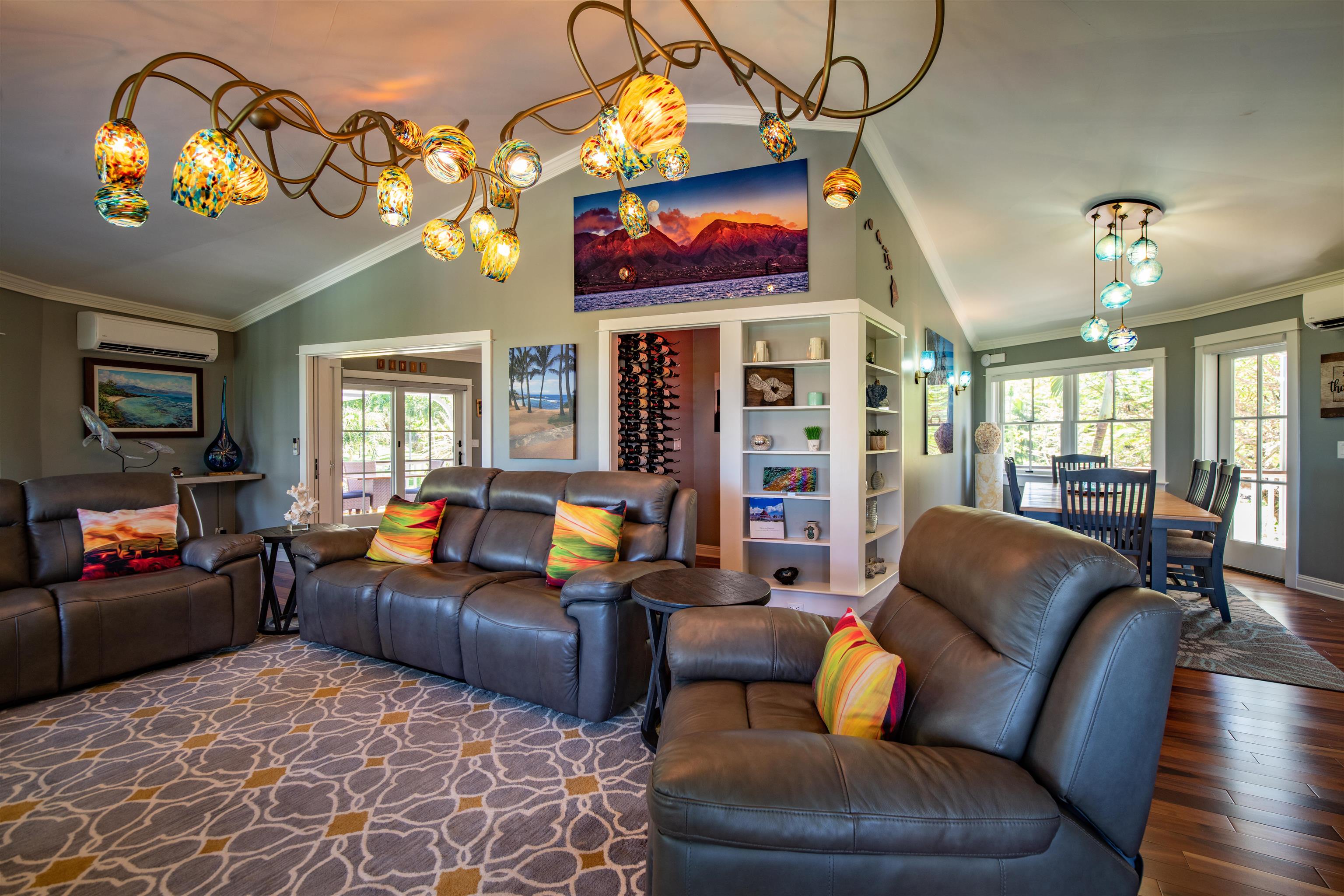 65 North Holokai Road Haiku, HI 96708 - Photo 15 of 50 a living room with furniture a chandelier and a flat screen tv