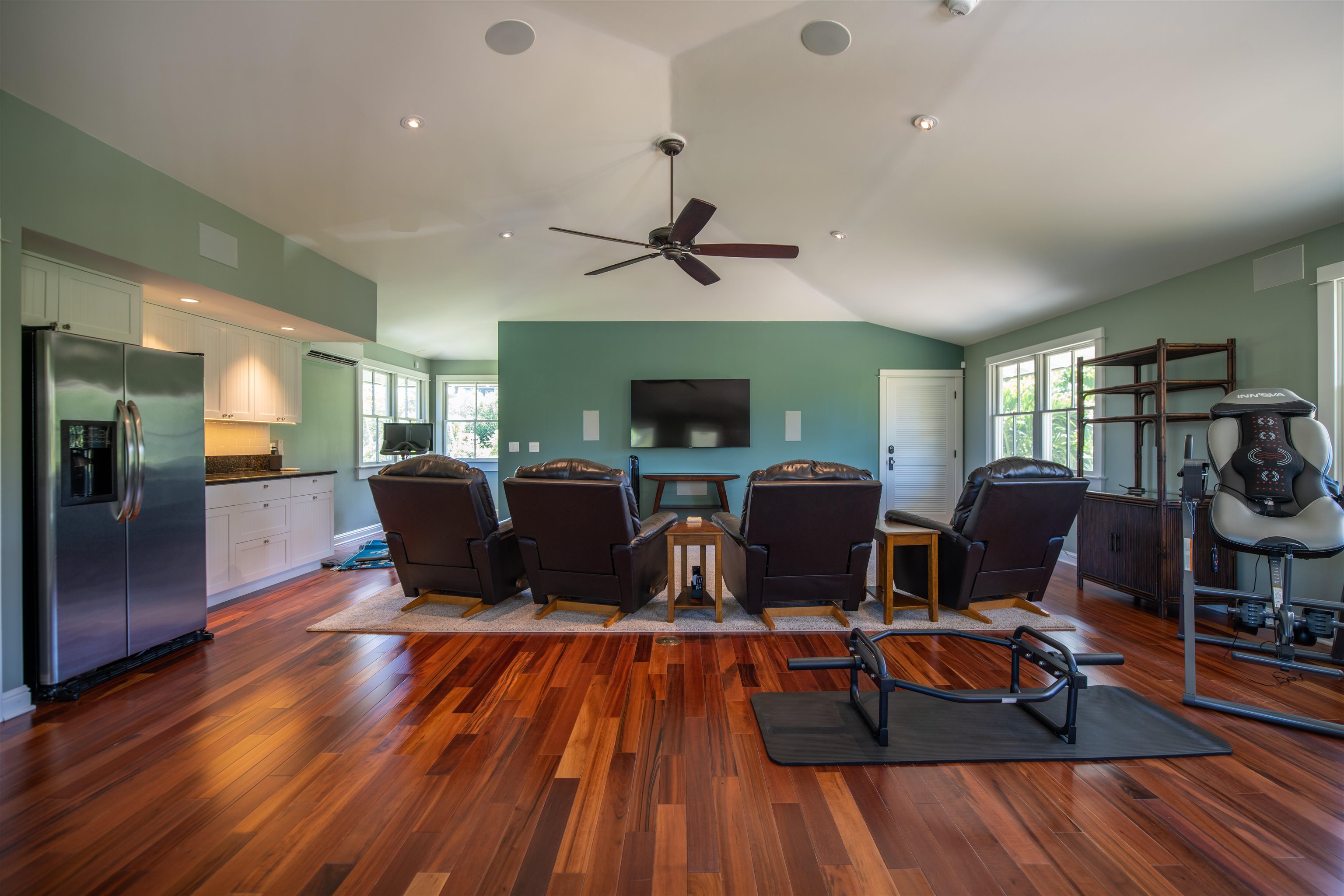 65 North Holokai Road Haiku, HI 96708 - Photo 29 of 50 a living room with furniture a fireplace and a flat screen tv