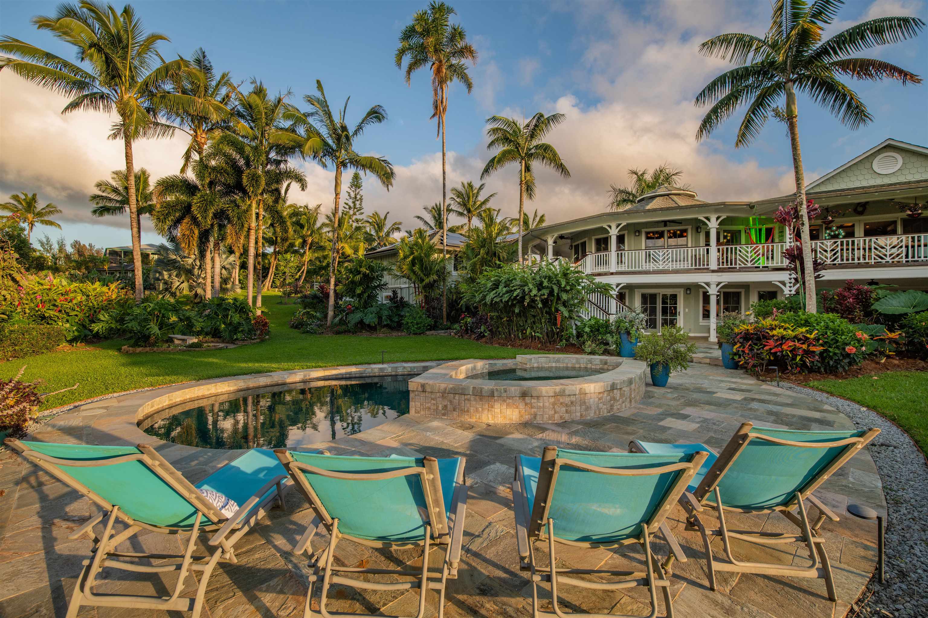 65 North Holokai Road Haiku, HI 96708 - Photo 30 of 50 a view of a swimming pool with a table and chairs under an umbrella