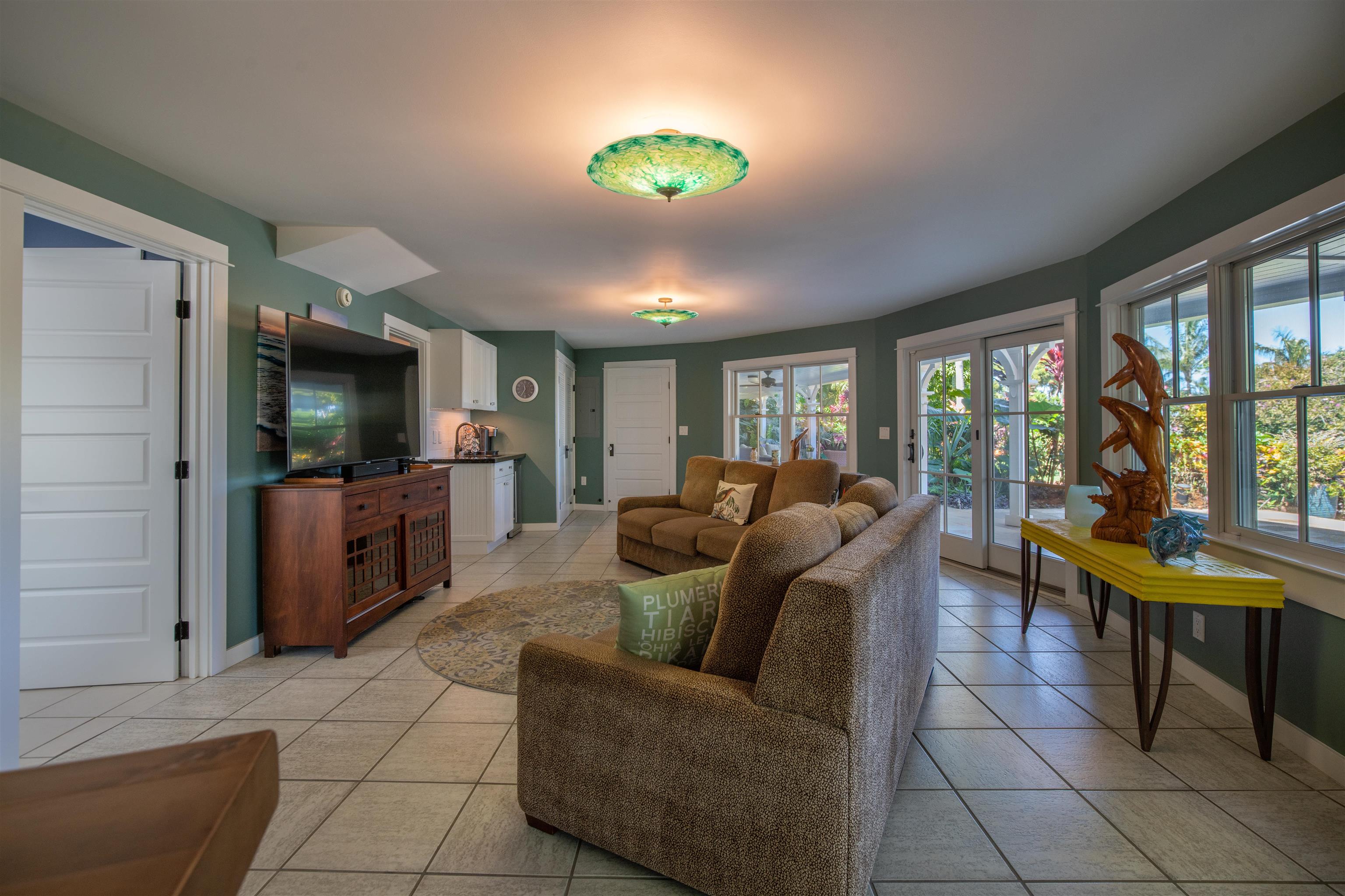 65 North Holokai Road Haiku, HI 96708 - Photo 34 of 50 a living room with furniture and a flat screen tv