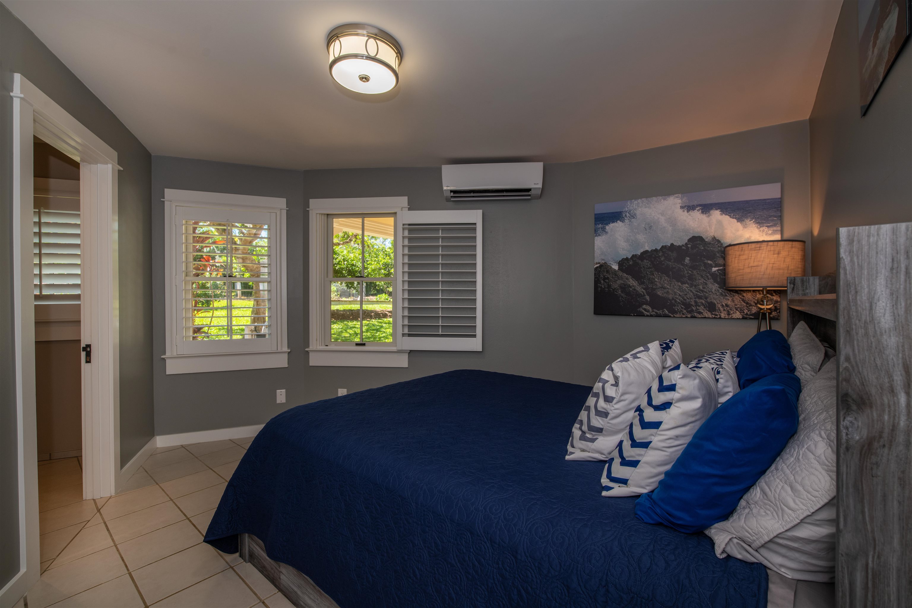 65 North Holokai Road Haiku, HI 96708 - Photo 38 of 50 a bed sitting in a bedroom next to a window