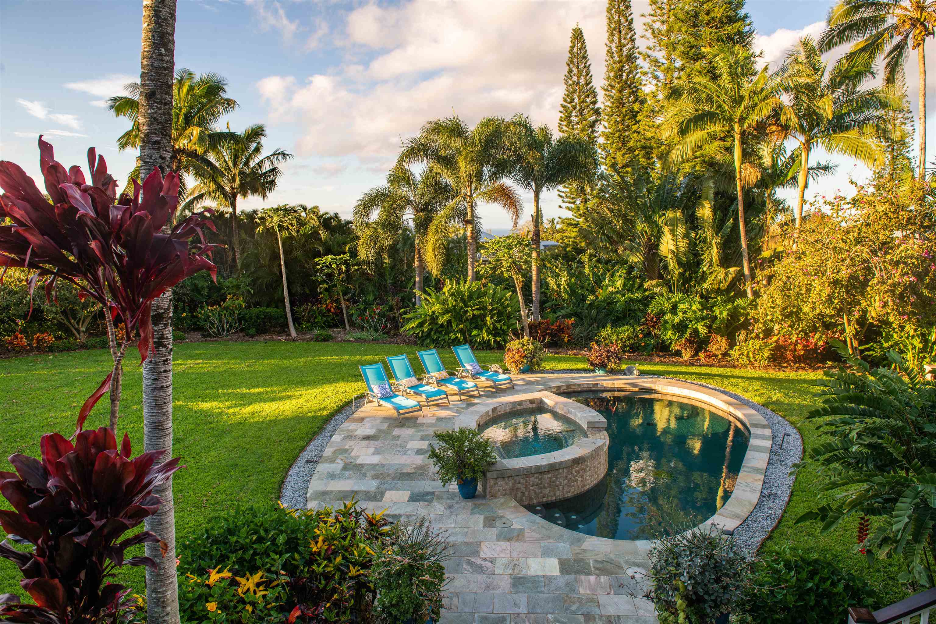 65 North Holokai Road Haiku, HI 96708 - Photo 44 of 50 a view of a swimming pool with a patio and garden