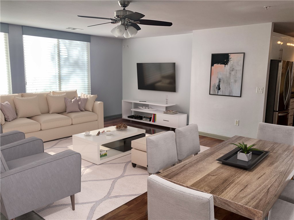 54 Rainey Street, Unit 101 Austin, TX 78701 - Photo 1 of 1 a living room with furniture and a flat screen tv