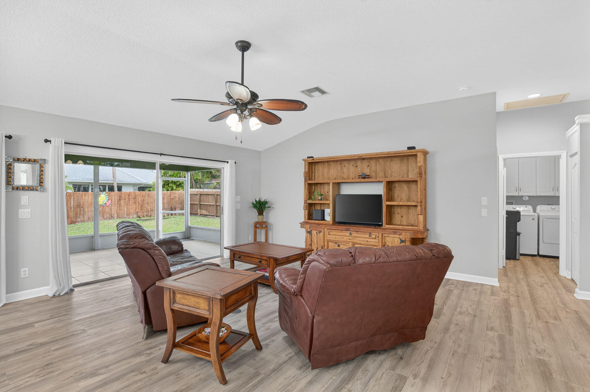 9275 Southeast Mercury Street Hobe Sound, FL 33455 - Photo 22 of 65 a living room with furniture and a flat screen tv