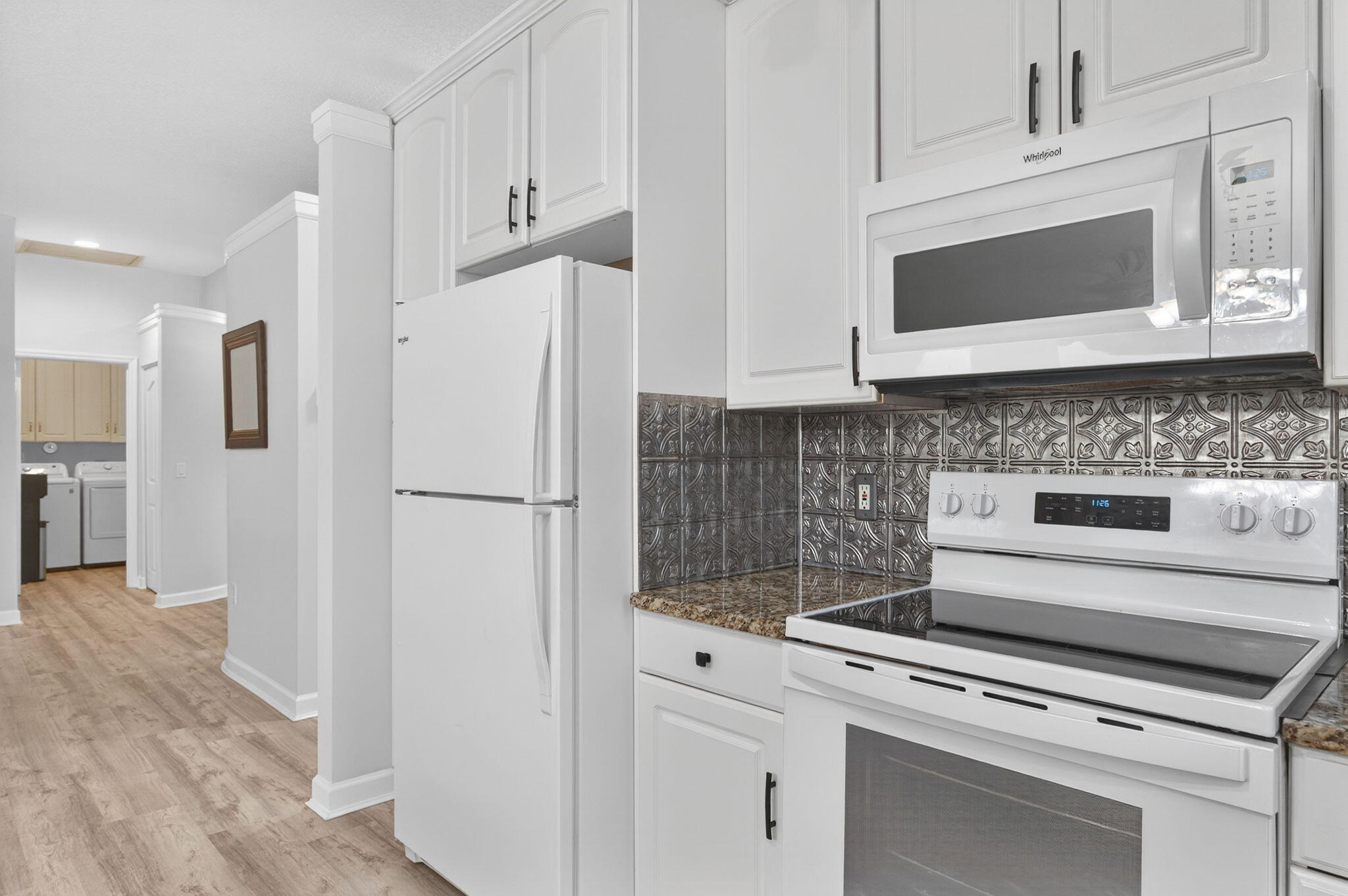 9275 Southeast Mercury Street Hobe Sound, FL 33455 - Photo 29 of 65 a kitchen with cabinets and stainless steel appliances