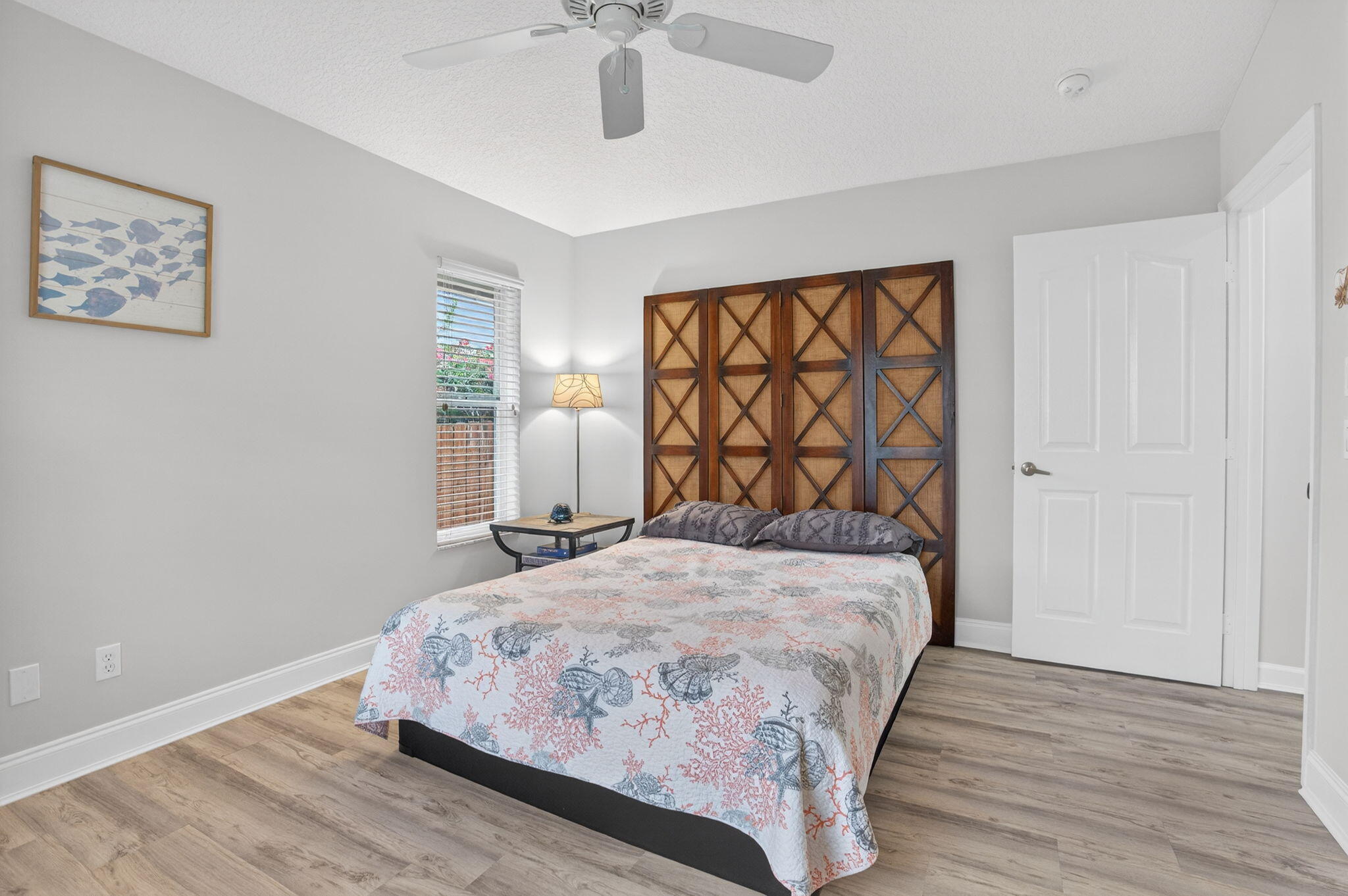 9275 Southeast Mercury Street Hobe Sound, FL 33455 - Photo 35 of 65 a bedroom with a bed and wooden floor