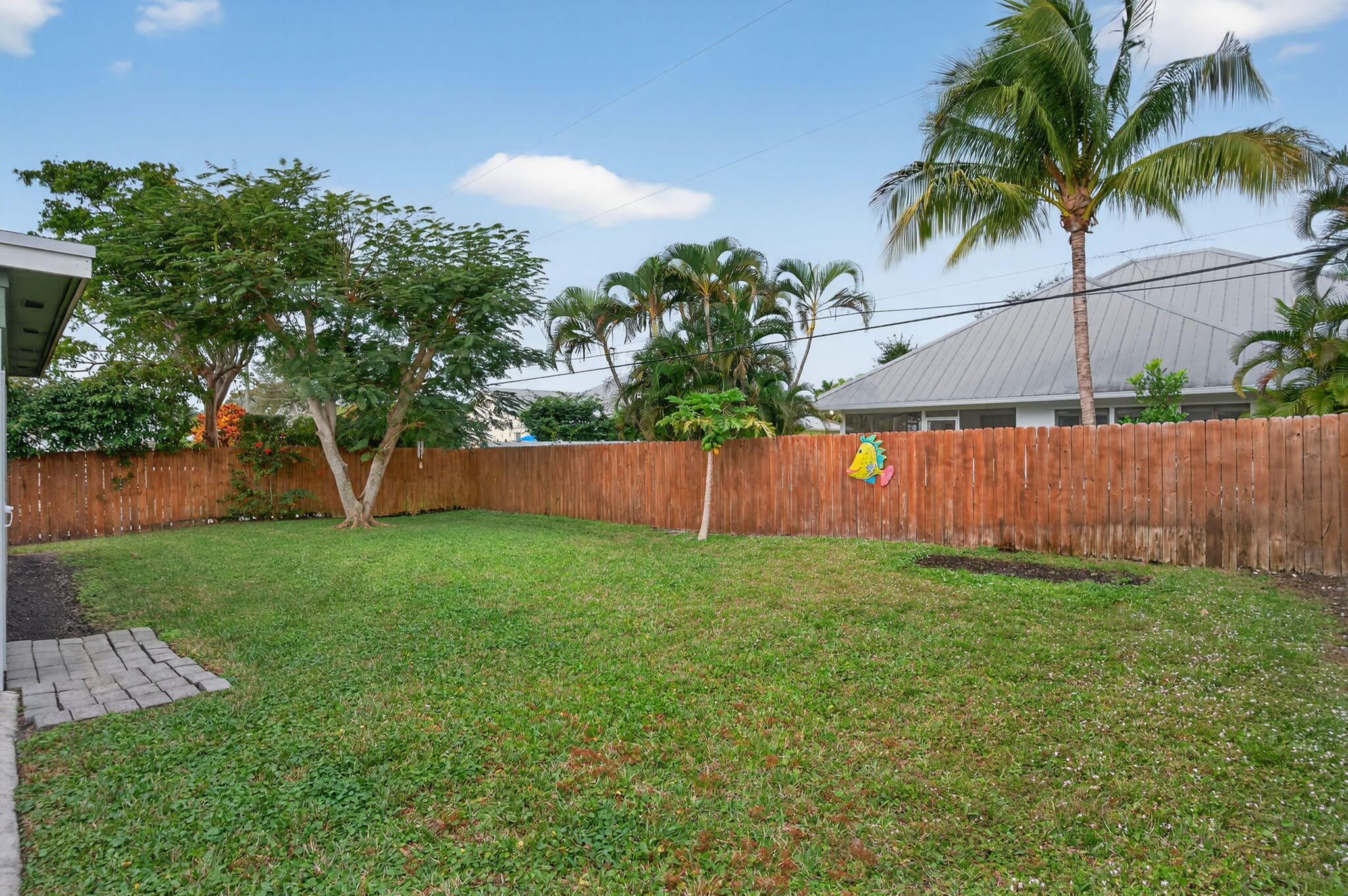 9275 Southeast Mercury Street Hobe Sound, FL 33455 - Photo 46 of 65 a view of a backyard with a garden