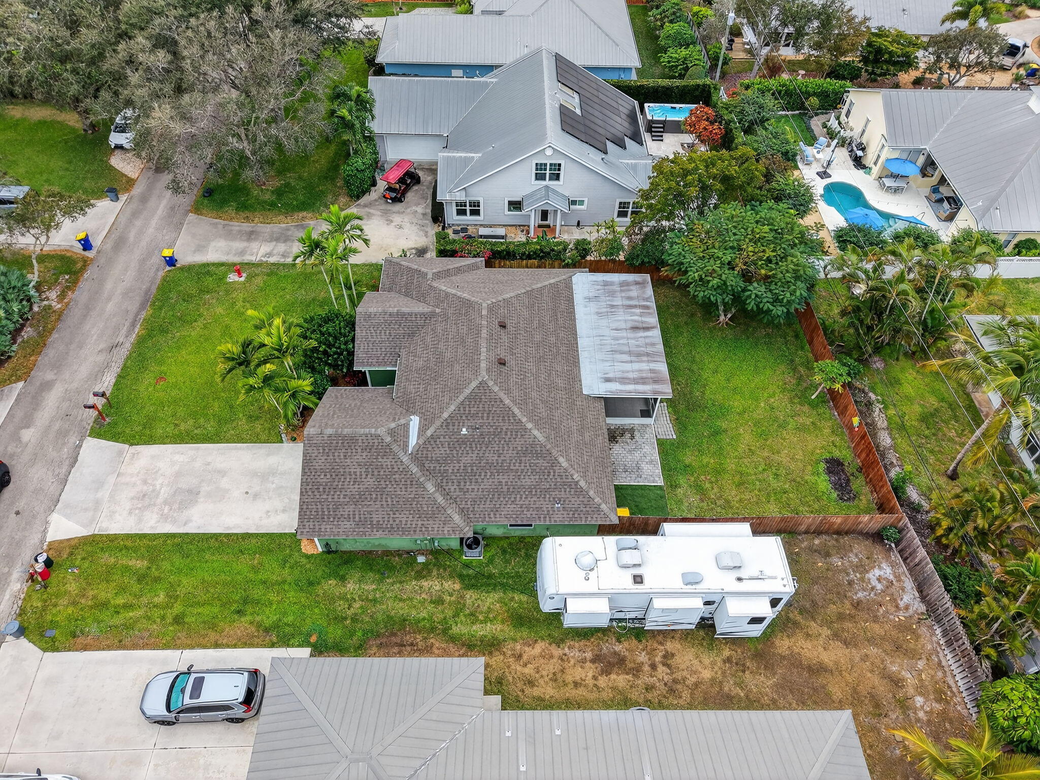 9275 Southeast Mercury Street Hobe Sound, FL 33455 - Photo 50 of 65 an aerial view of a house with a garden and yard