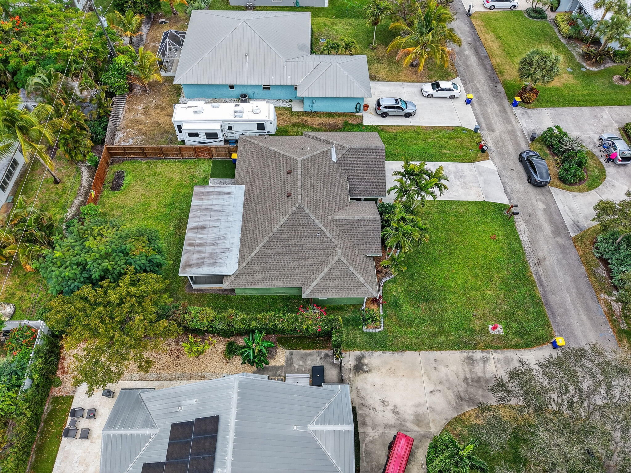 9275 Southeast Mercury Street Hobe Sound, FL 33455 - Photo 54 of 65 an aerial view of multiple houses with yard