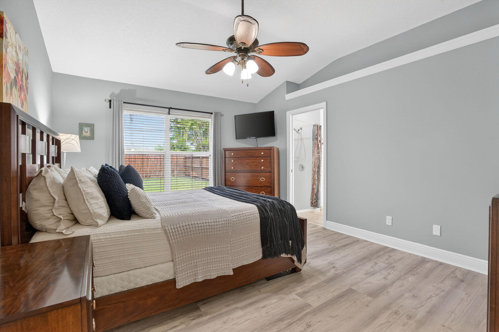 9275 Southeast Mercury Street Hobe Sound, FL 33455 - Photo 6 of 65 a bedroom with a bed and a ceiling fan