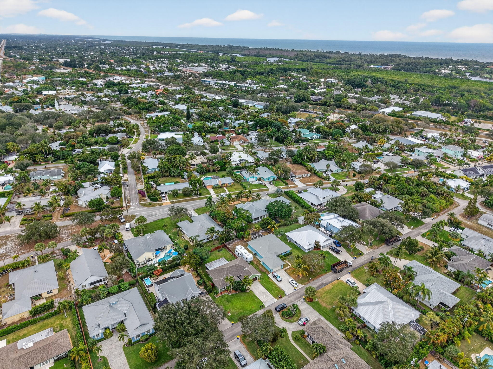 9275 Southeast Mercury Street Hobe Sound, FL 33455 - Photo 63 of 65 an aerial view of residential houses with outdoor space and trees