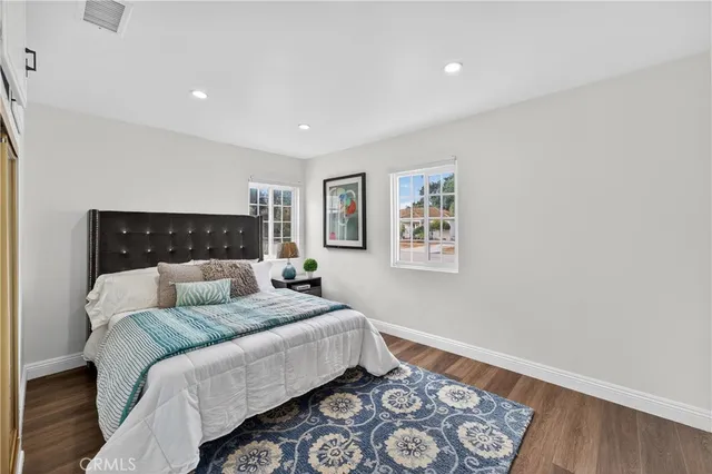 a bedroom with a bed and painting on the wall