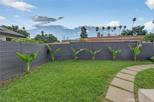 a view of a kitchen with a sink cabinets and wooden floor