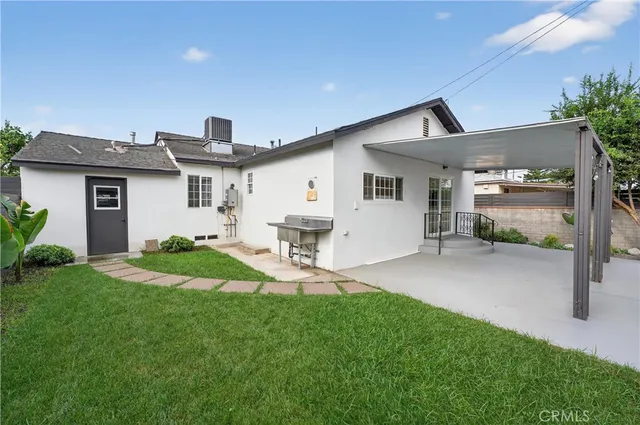 a large kitchen with stainless steel appliances kitchen island a large counter top and a stove top oven
