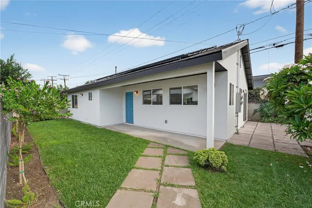 a large kitchen with stainless steel appliances refrigerator sink and cabinets