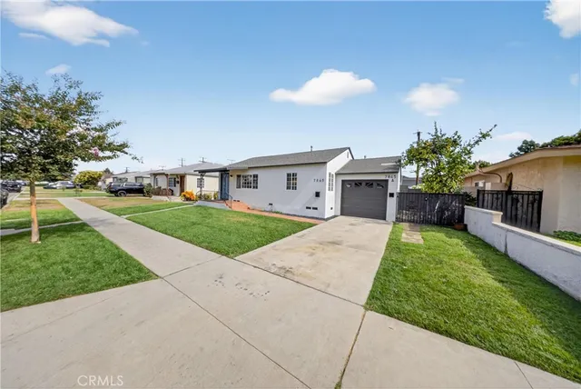 a front view of a house with a garden