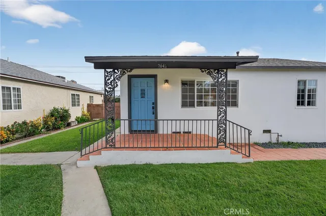 a living room with furniture a rug and a table