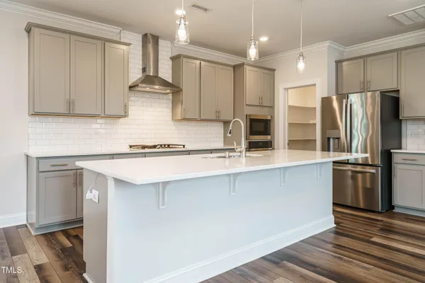 a kitchen with stainless steel appliances granite countertop a refrigerator and a sink