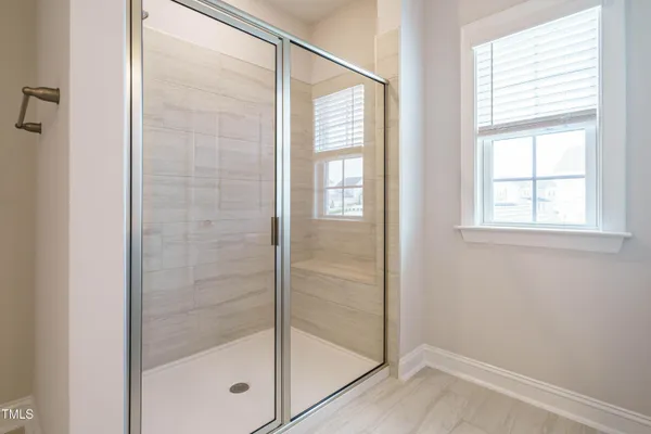a bathroom with a glass shower door