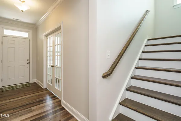 a view of entryway with wooden floor and stairs
