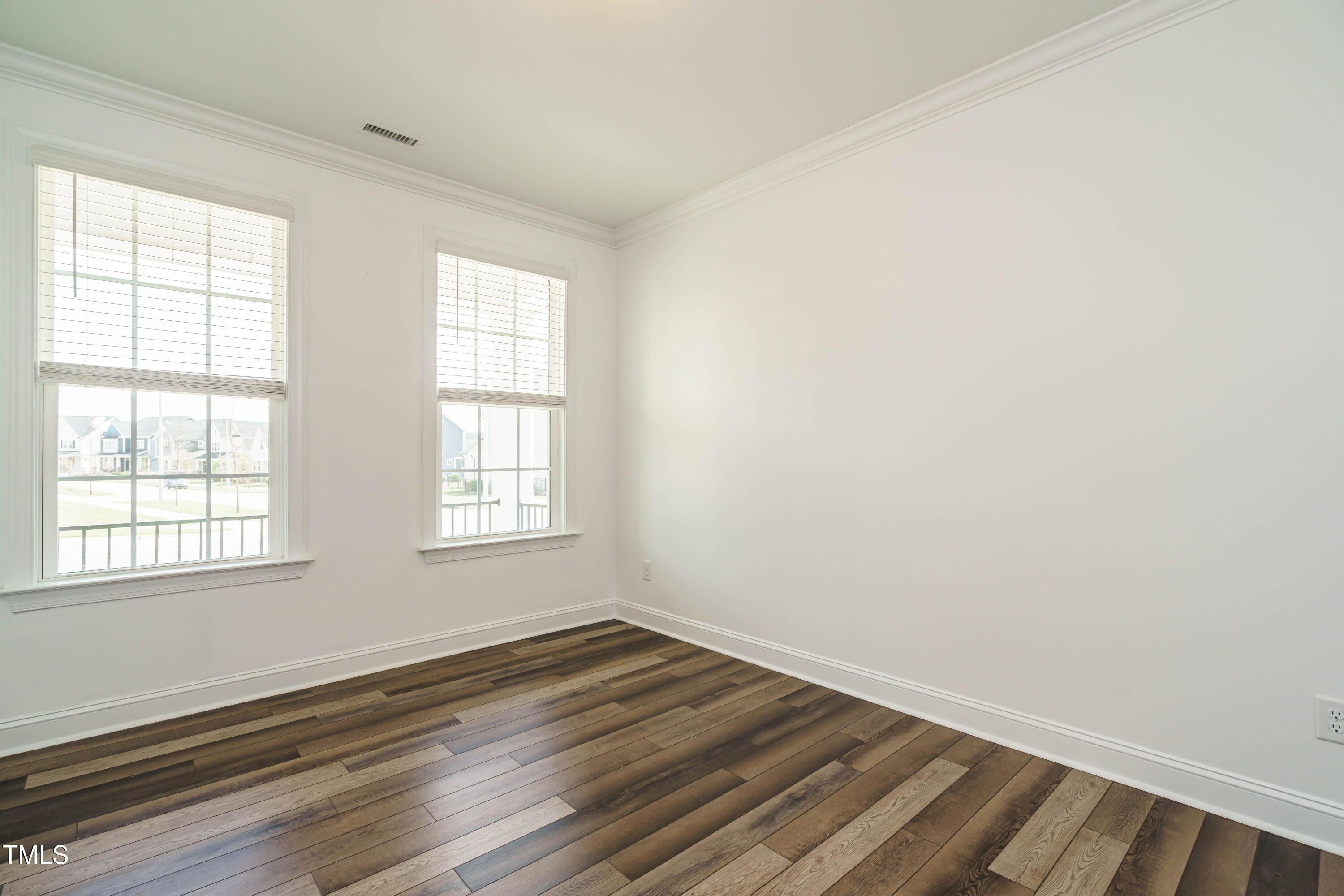 5201 Influence Way Raleigh, NC 27616 - Photo 5 of 33 an empty room with wooden floor and windows