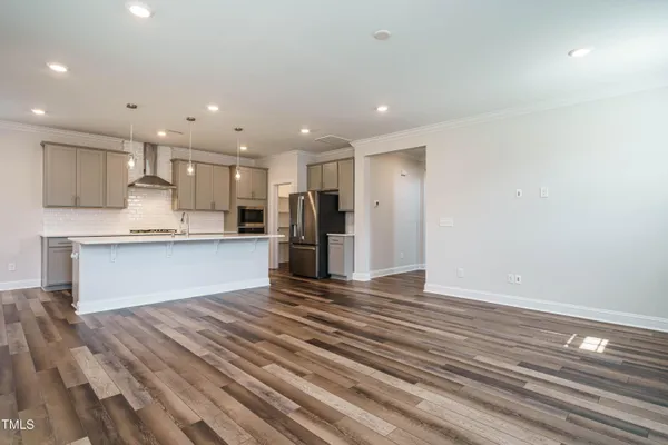 a view of kitchen with wooden floor and electronic appliances
