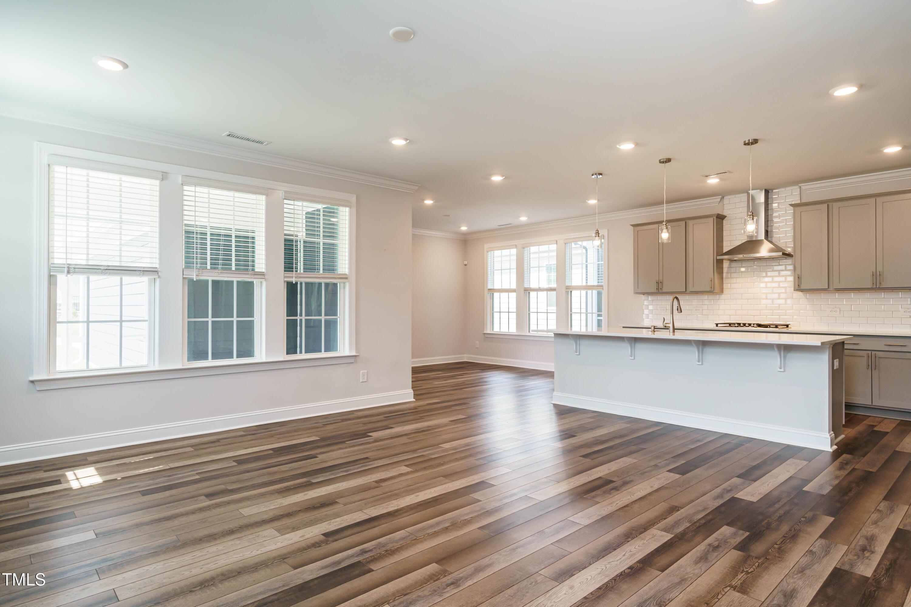 5201 Influence Way Raleigh, NC 27616 - Photo 10 of 33 an open kitchen with white cabinets and wooden floor