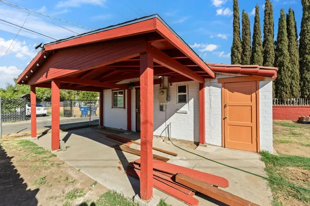 a view of a house with wooden deck and furniture