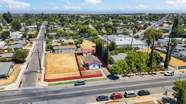 an aerial view of residential houses with outdoor space and street view