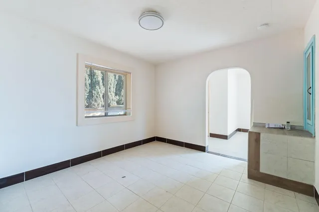 a view of a room with gym equipment and a window