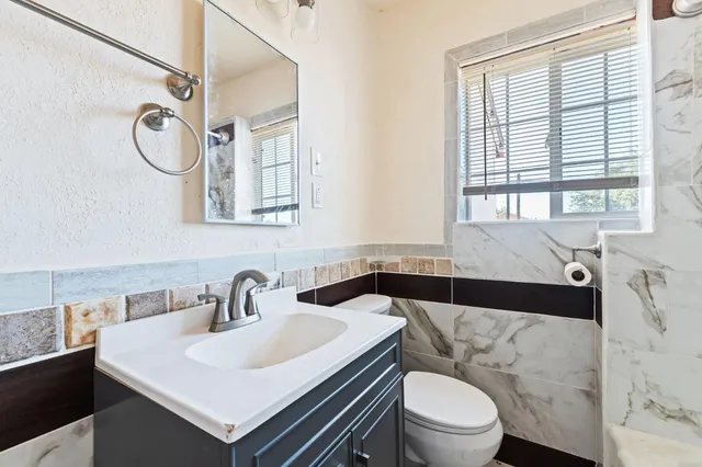 a bathroom with a sink a toilet and a bathtub