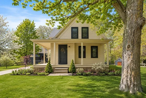 a front view of a house with a garden