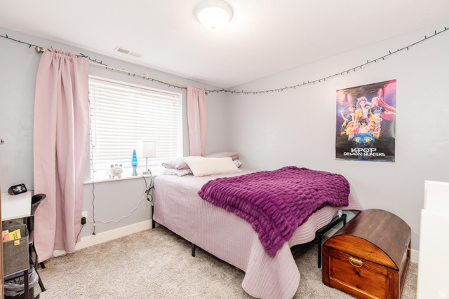 972 West 2840th Street South Logan, UT 84321 - Photo 27 of 46 Carpeted room with a large window featuring white blinds and pink drapery