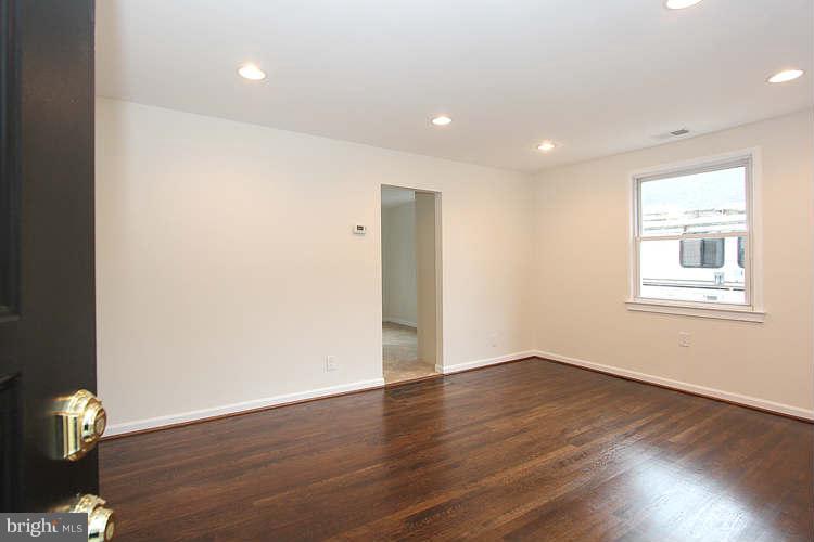 8129 Bullneck Road Baltimore, MD 21222 - Photo 11 of 30 a view of an empty room with wooden floor and a window