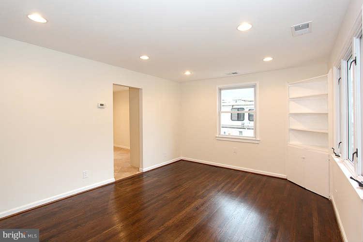 8129 Bullneck Road Baltimore, MD 21222 - Photo 12 of 30 an empty room with wooden floor and windows