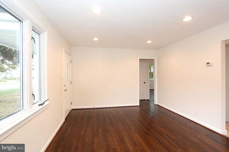 8129 Bullneck Road Baltimore, MD 21222 - Photo 13 of 30 a view of an empty room with wooden floor and a window