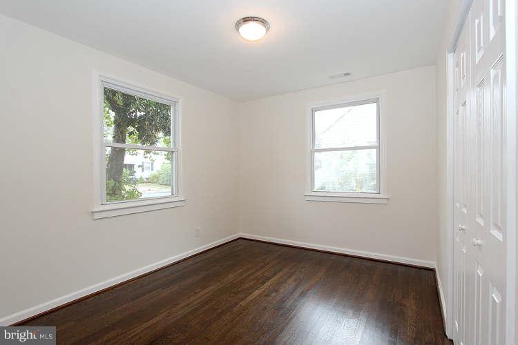 8129 Bullneck Road Baltimore, MD 21222 - Photo 17 of 30 a view of an empty room with wooden floor and a window