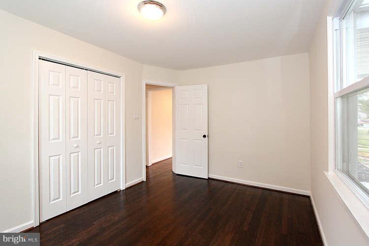 8129 Bullneck Road Baltimore, MD 21222 - Photo 19 of 30 an empty room with wooden floor and windows