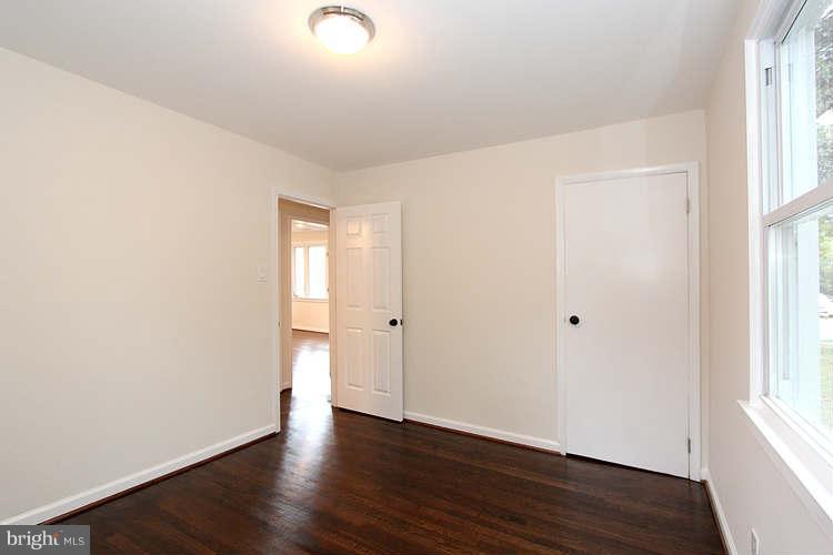 8129 Bullneck Road Baltimore, MD 21222 - Photo 22 of 30 an empty room with wooden floor and windows