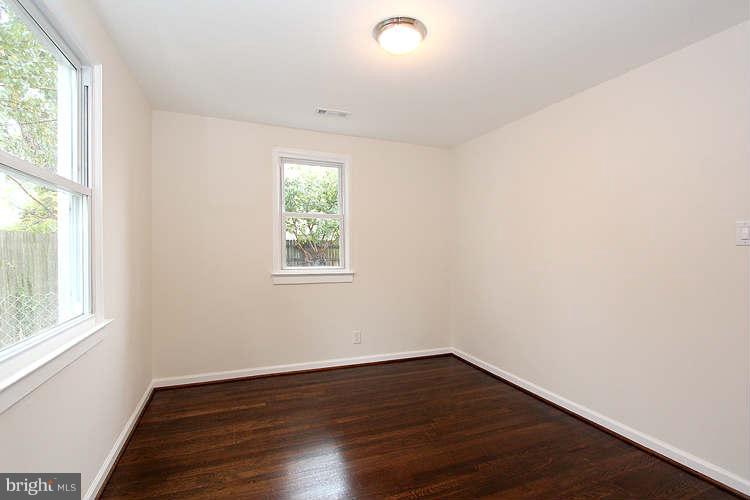 8129 Bullneck Road Baltimore, MD 21222 - Photo 23 of 30 an empty room with wooden floor and windows